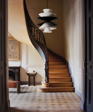 Foyer with modern chandelier and helical staircase