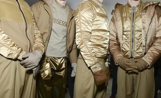 Three models wearing gold jackets