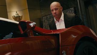 Vin Diesel lifting a car in Furious 7