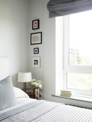 A bedroom with white walls and white bedding