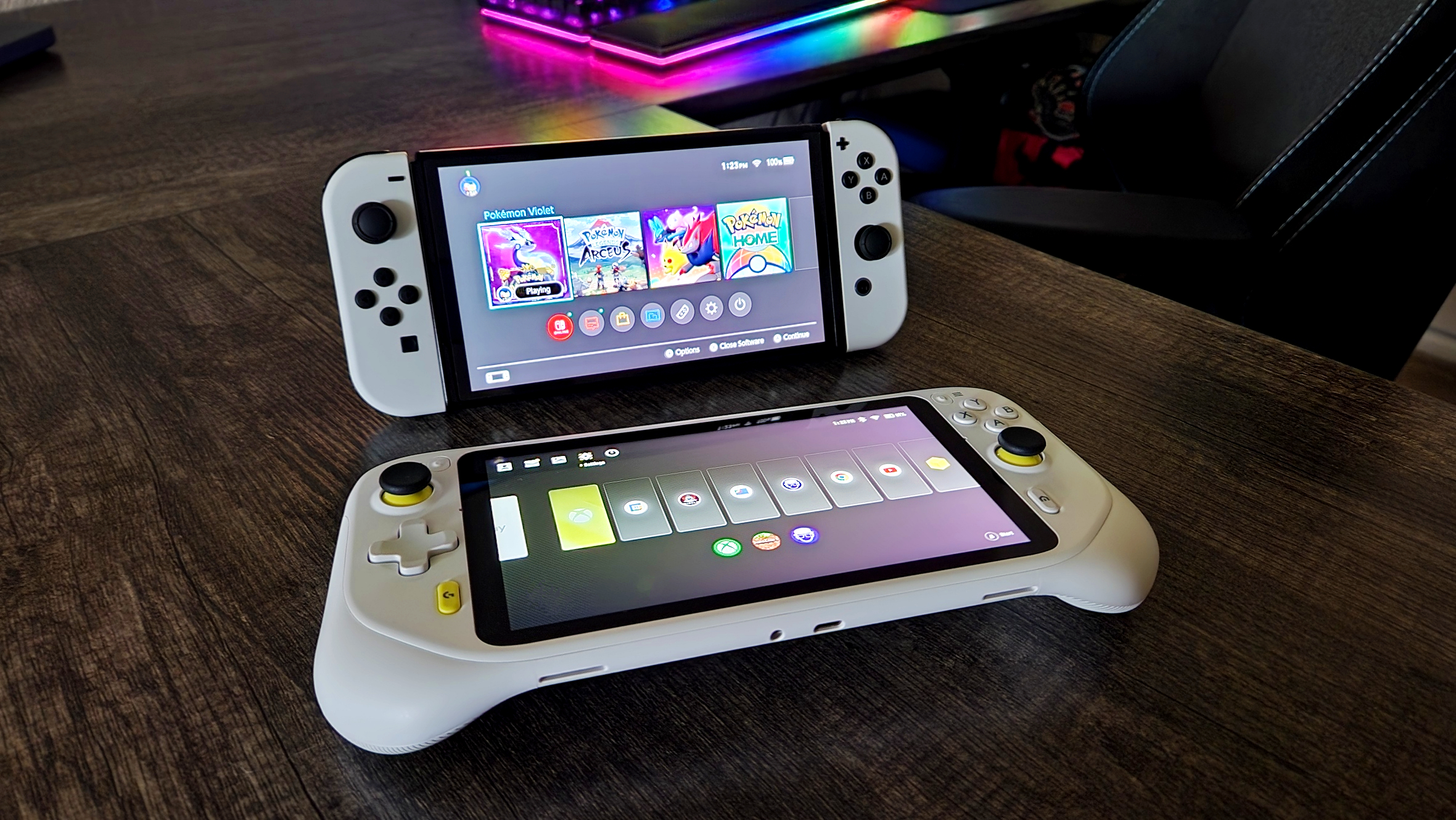 Logitech G Cloud flat on desk with Nintendo Switch OLED standing behind it.