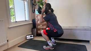 James Frew doing a dumbbell workout in the Centr app