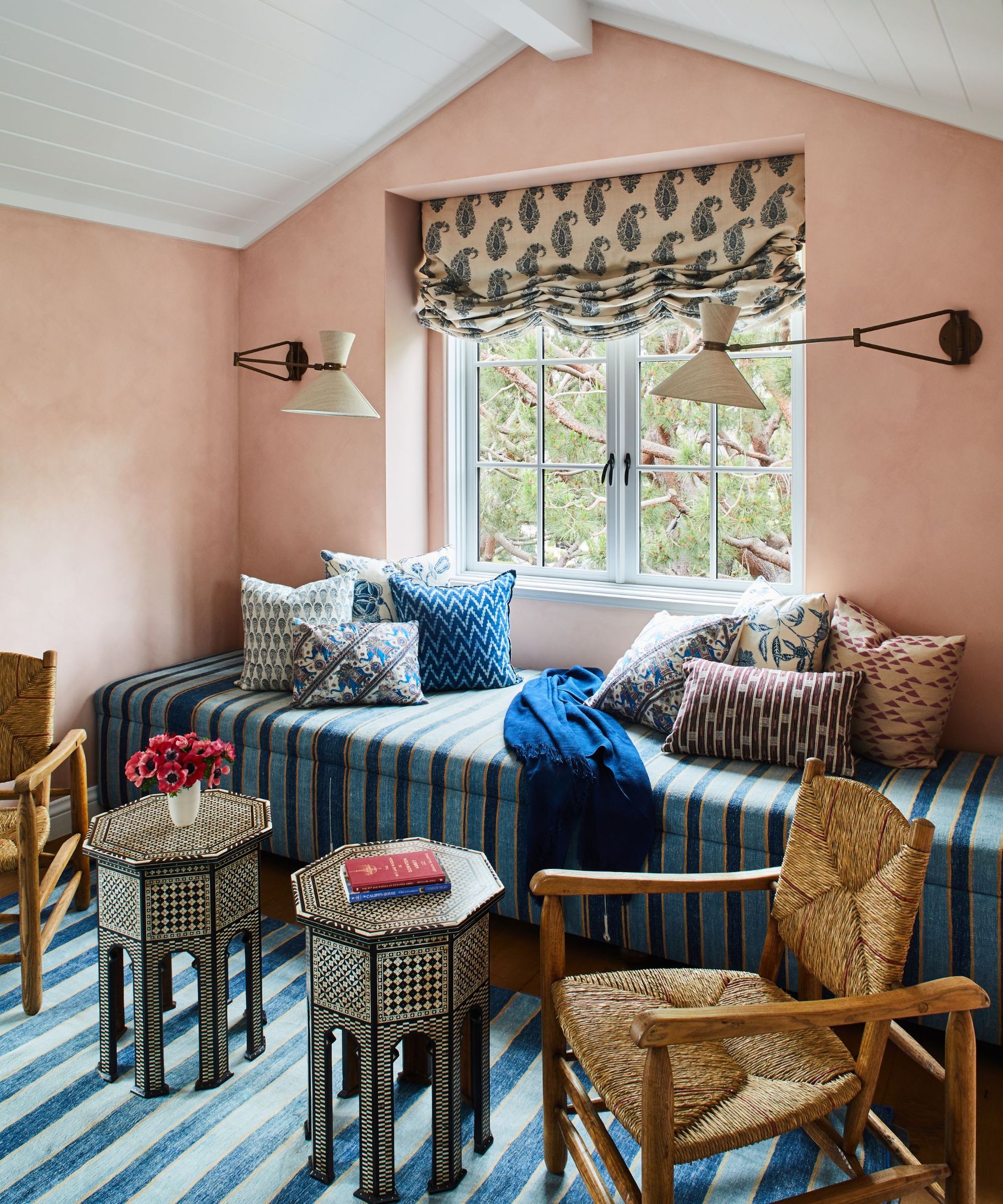 a paisley relaxed roman blind in a window nook seat