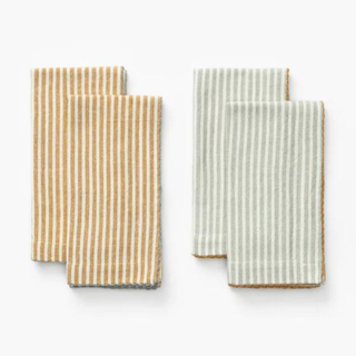 Two striped napkins, one yellow and one green.
