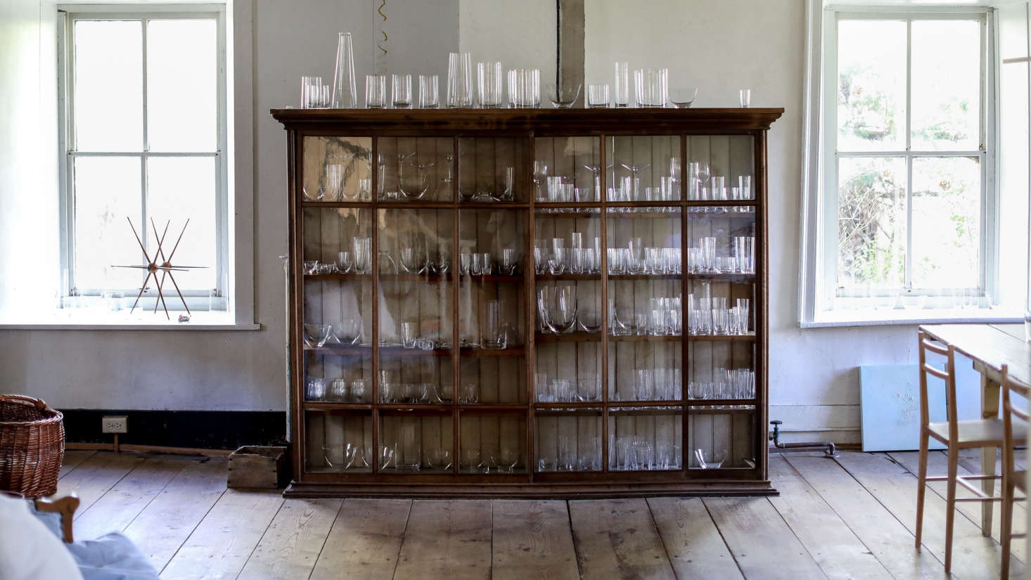 wood cabinet filled with a collection of glassware
