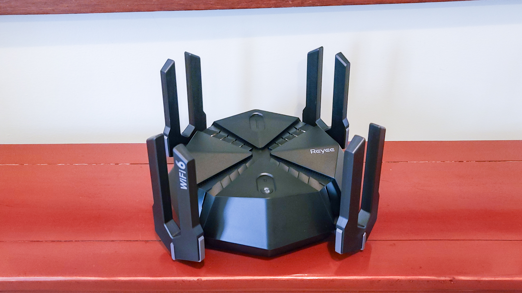 Reyee RG-E6 gaming router on a bench