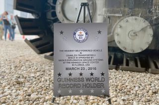 A sign positioned near one of the giant tracks of NASA's Crawler-Transporter 2 identifies the Artemis-upgraded, Apollo-era vehicle as a Guinness World Record holder.