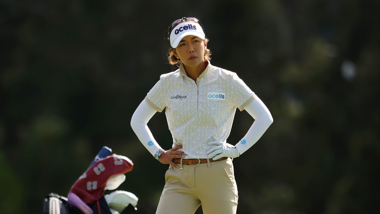 Jenny Shin stands with her hands on her hips at the 2023 Australian Open