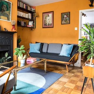 orange living room with grey sofa