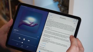 iPad Air 5 in hands with Apple Music and Notes app open in Split view