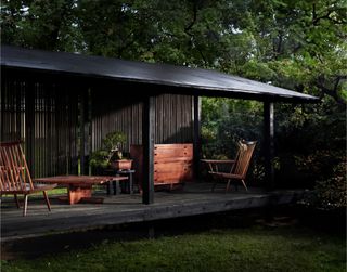 george nakashima furniture on a covered porch outside