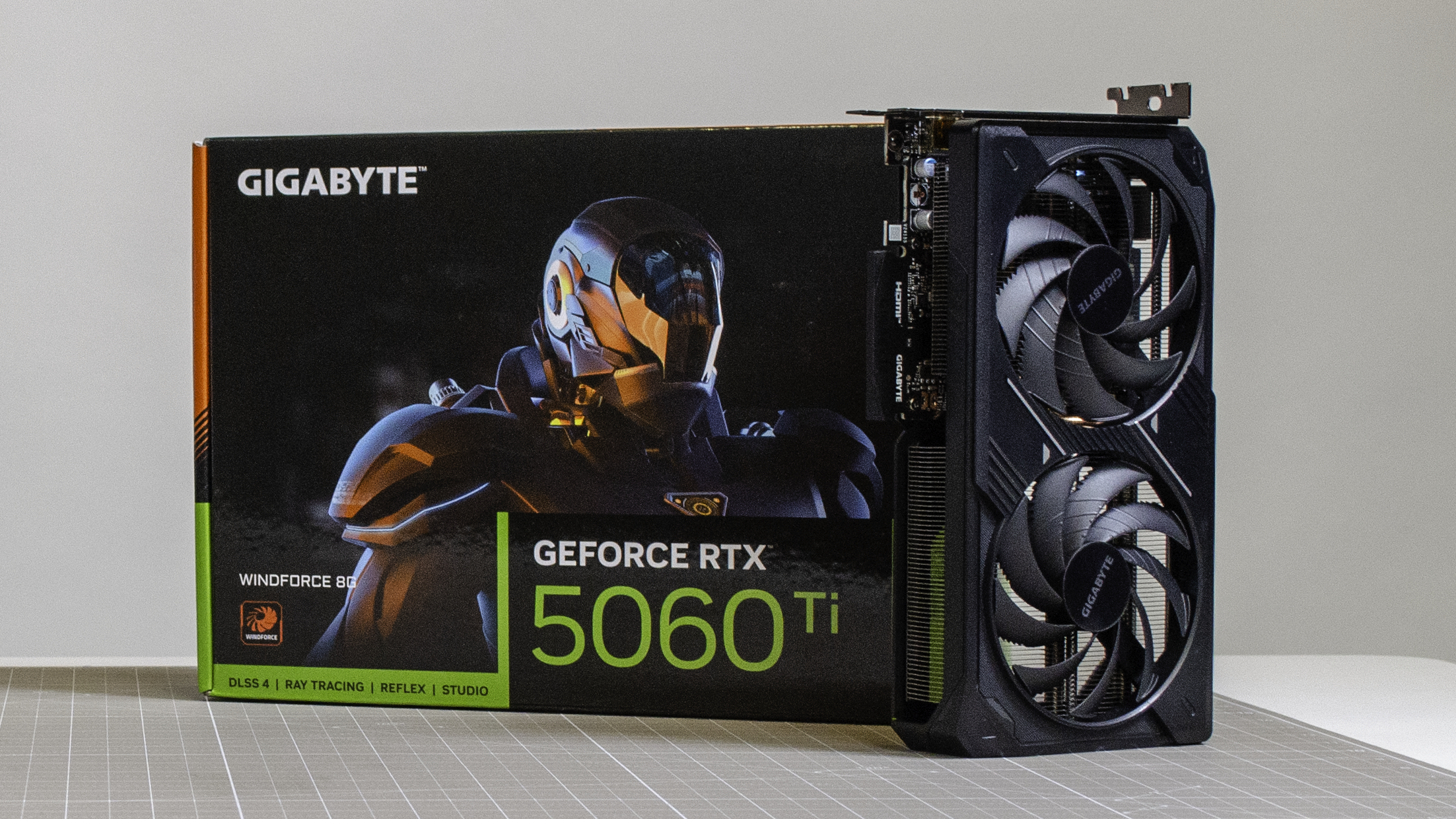 An RTX 5060 Ti 8GB on a desk with its retail packaging