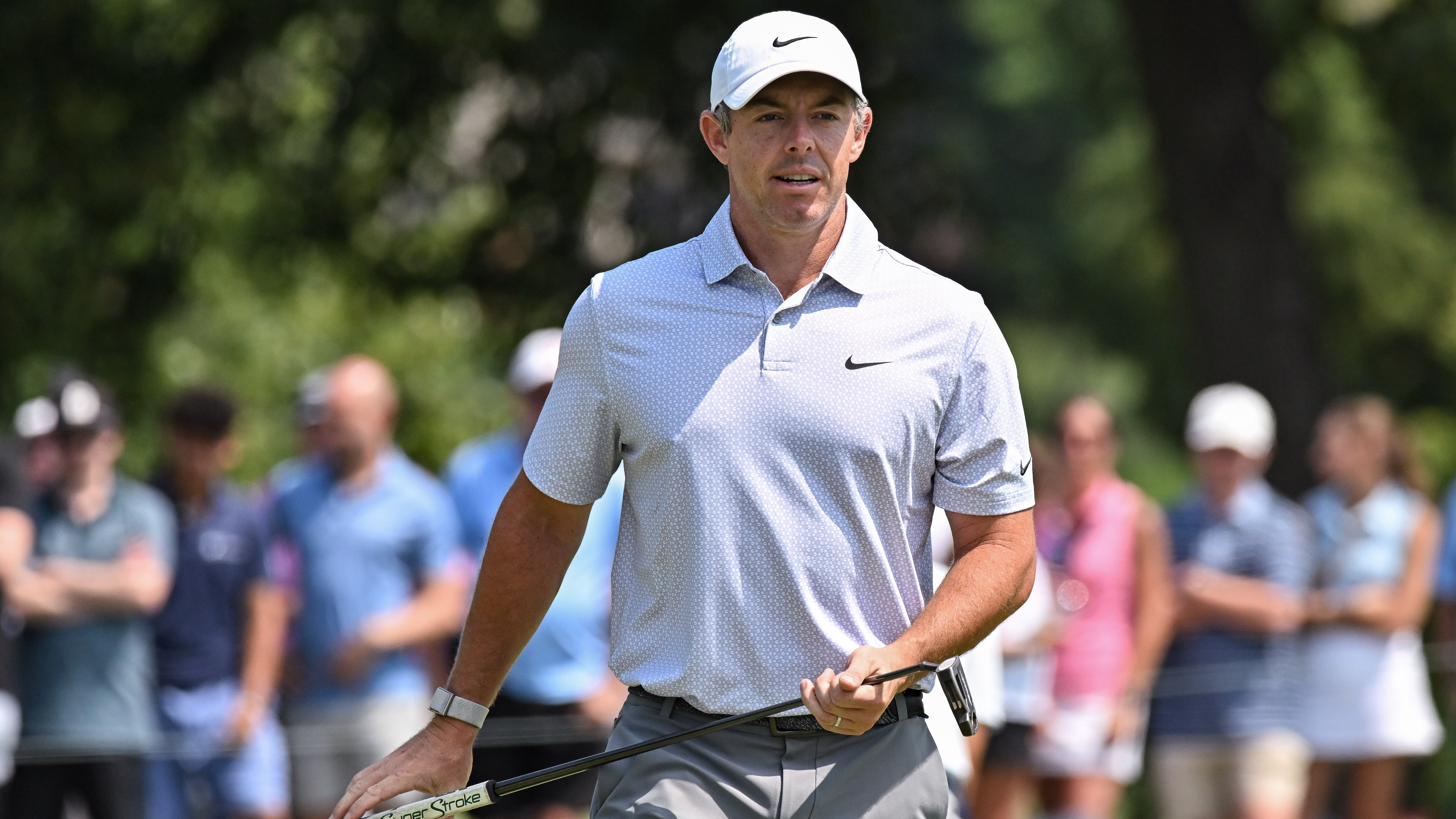 Rory McIlroy of Northern Ireland walks off the 1st green holding his Super Stroke putter during the third round of the PGA BMW Championship