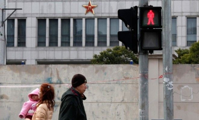 Locals walk in front of Unit 61398, a secretive Chinese military unit on the outskirts of Shanghai on Feb. 19.