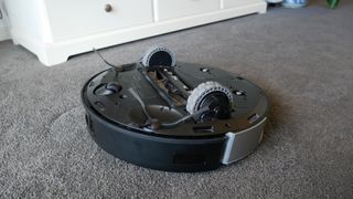 Ecovacs Deebot X1 Turbo sitting upside down, showing wheels