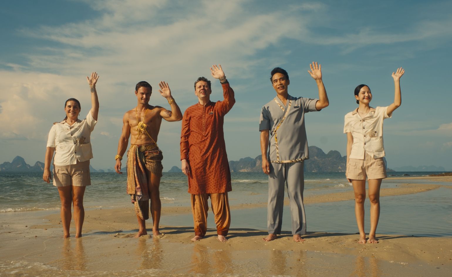 The White Lotus cast members waving on beach