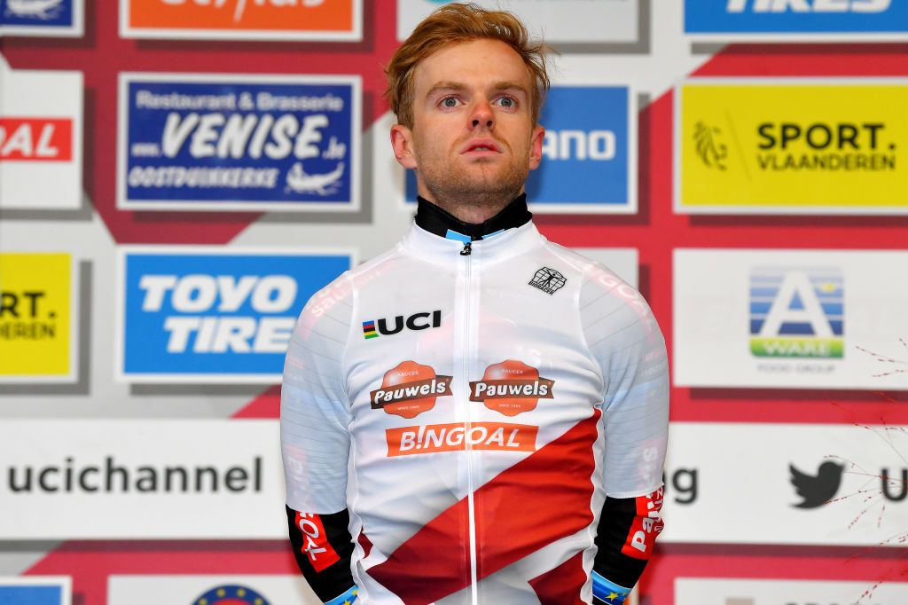 KOKSIJDE BELGIUM NOVEMBER 21 Eli Iserbyt of Belgium and Team Pauwels Sauzen Bingoal celebrates winning the race and leader WorldCup jersey on the podium ceremony after the 50th Koksijde UCI CycloCross Worldcup 2021 Mens Elite CXWorldCup on November 21 2021 in Koksijde Belgium Photo by Luc ClaessenGetty Images