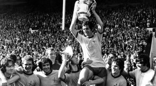 Arsenal lift the FA Cup following their 2-1 win over Liverpool - Holding the cup is victorious skipper Frank McLintock on the shoulders of winning goalscorer Charlie George (left) and Pat Rice. Date - 8th May 1971. (Photo by Mirrorpix via Getty Images)