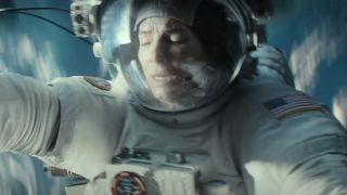Sandra Bullock shuts her eyes in panic while floating in space in Gravity.