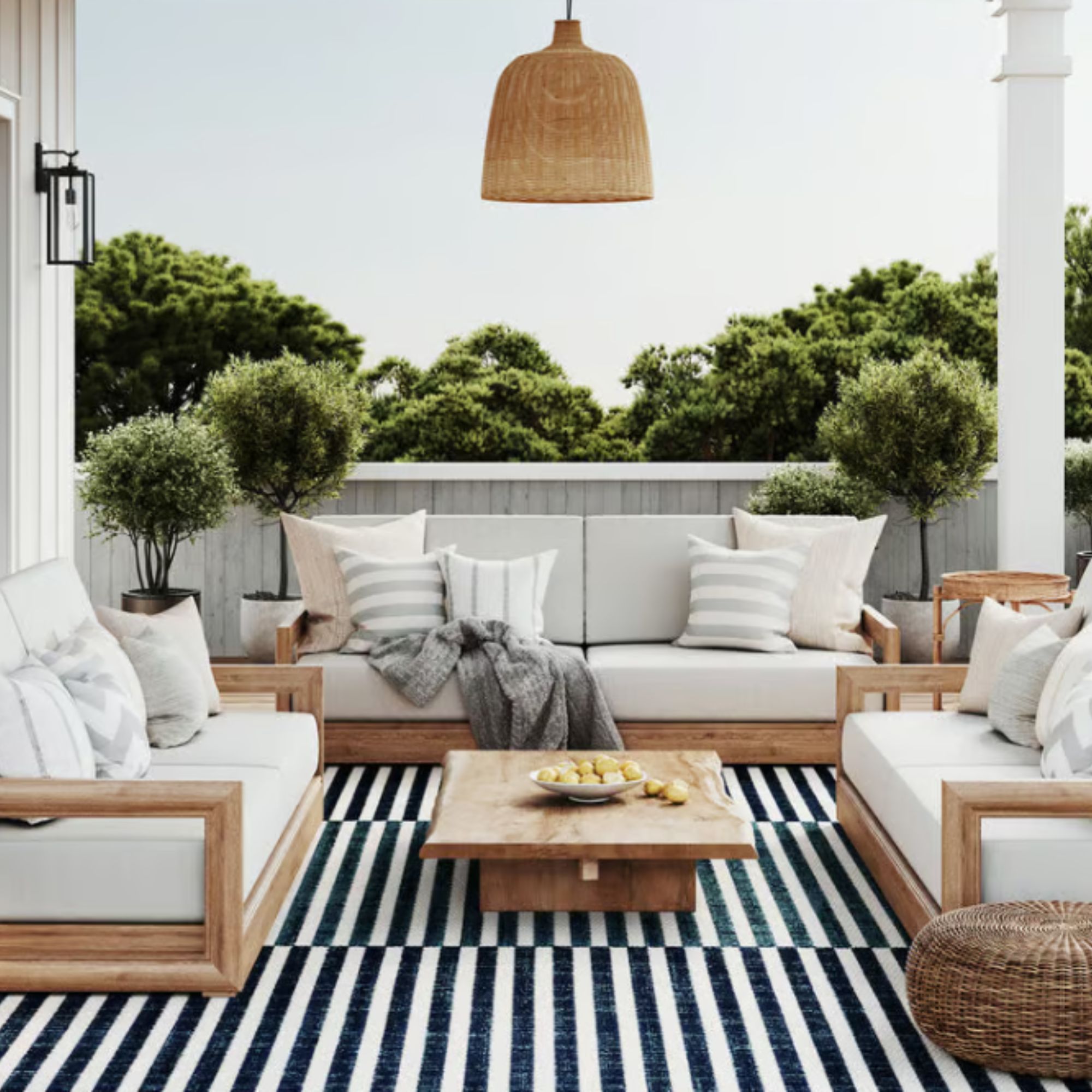 Colony Indoor/Outdoor Rug beneath white patio furniture set. 