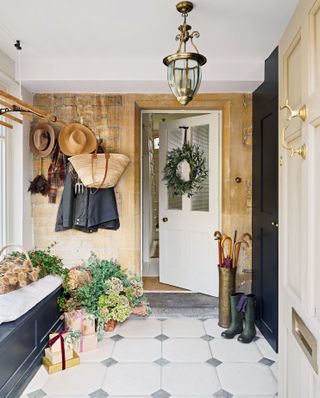 traditional-style bootroom with christmas greenery and decorations and tiled floor and vintage pendant light