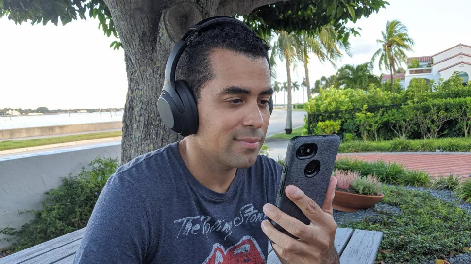 Our reviewer testing the Sony WH-1000XM4's call quality outside