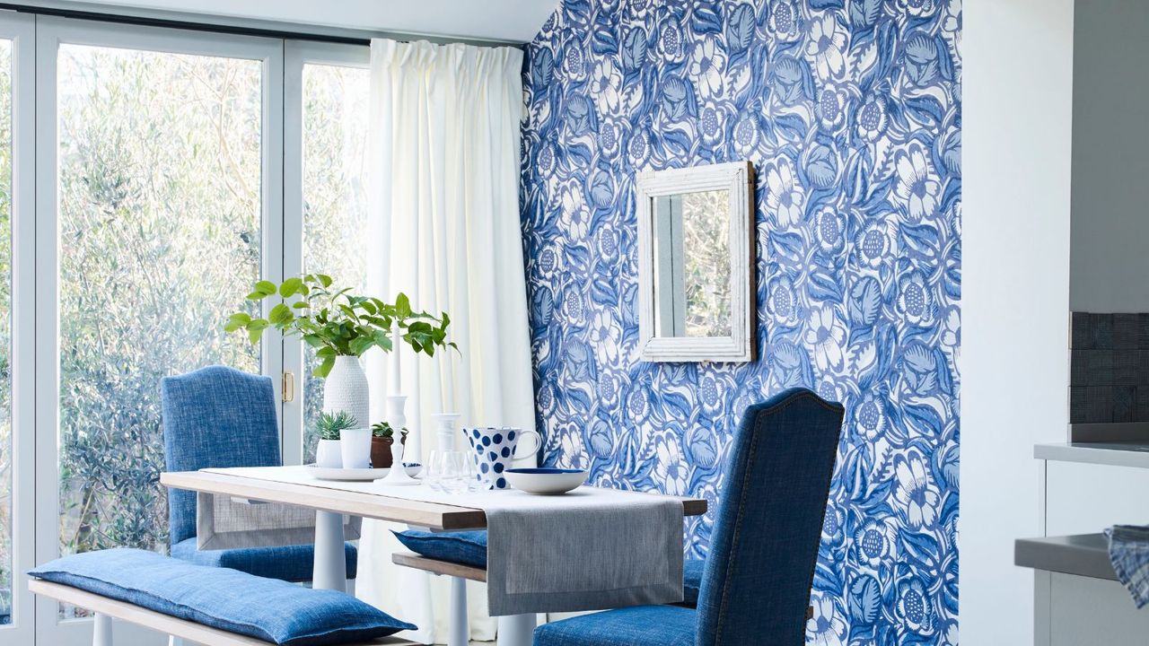 Blue dining room with white curtains, black curtain rod