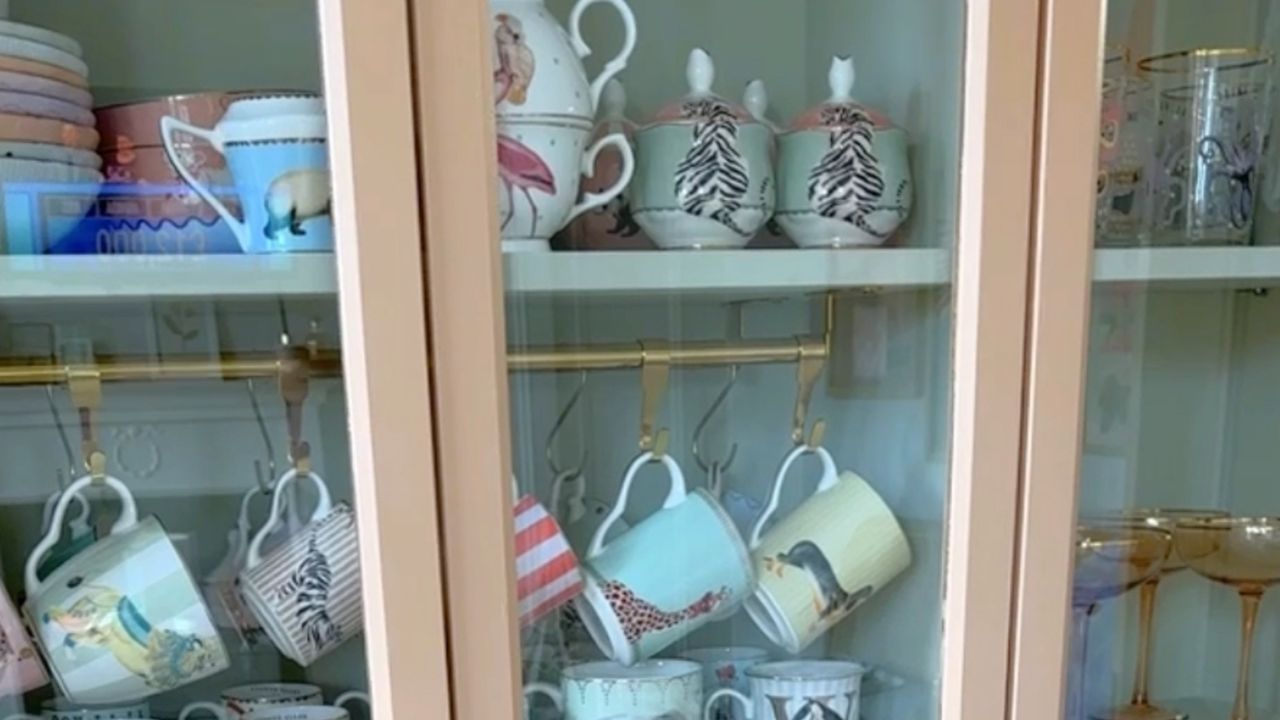 IKEA Billy bookcase after DIY transformation with various mugs and dinnerware displayed inside