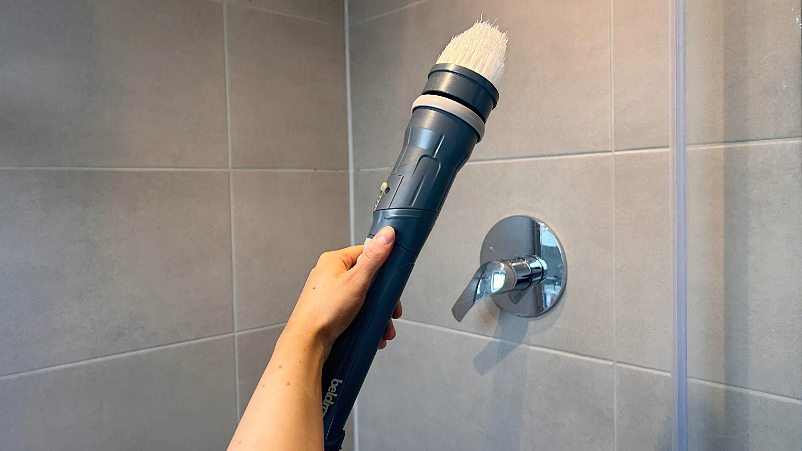 Megan's hand holding beldray shower cleaner