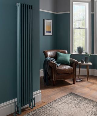 A teal living room corner idea with brown leather chair, teal radiator and wall decor