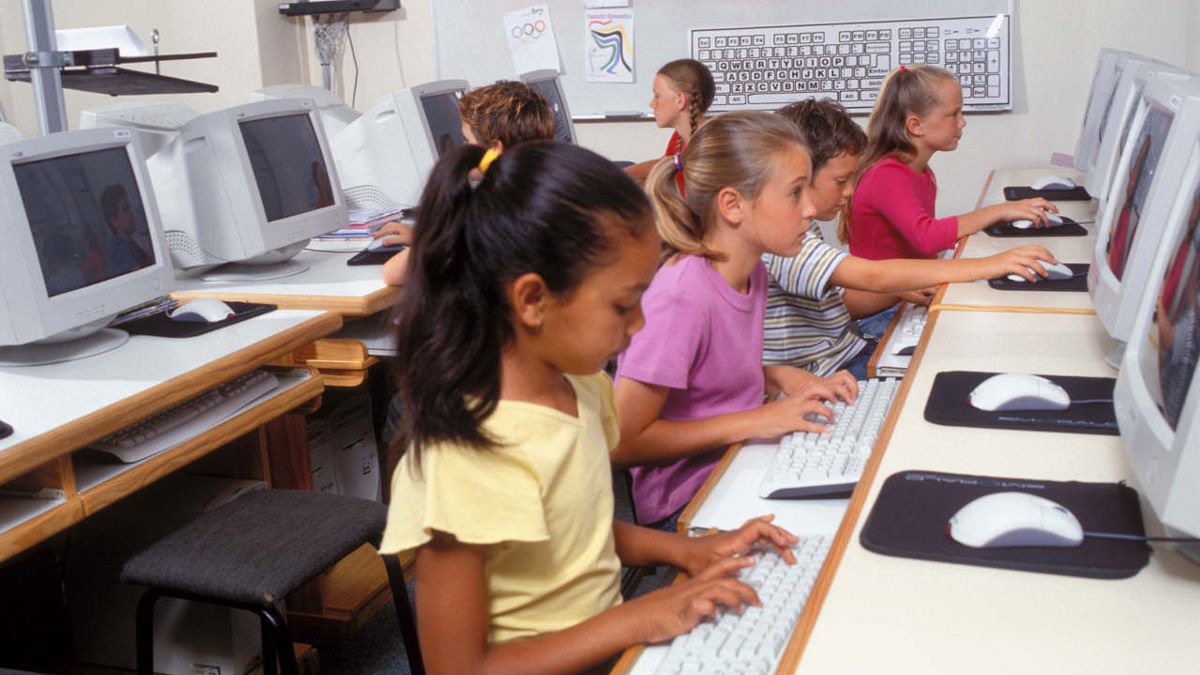 kids work at computers in a classroom