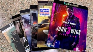 4K Blu-ray action movies splayed out on a kitchen counter