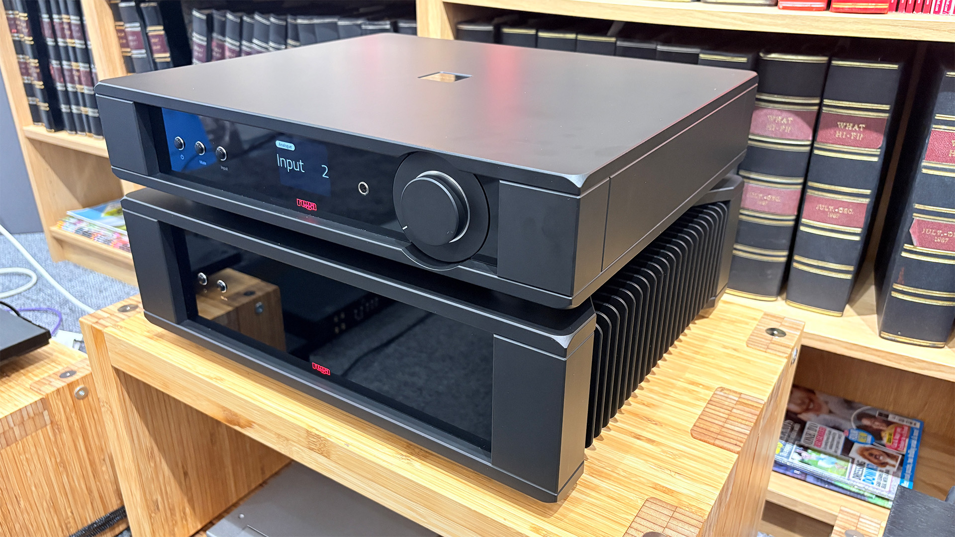 Rega Mercury/Solis pre/power amplifier on wooden hi-fi rack in front of bookcase