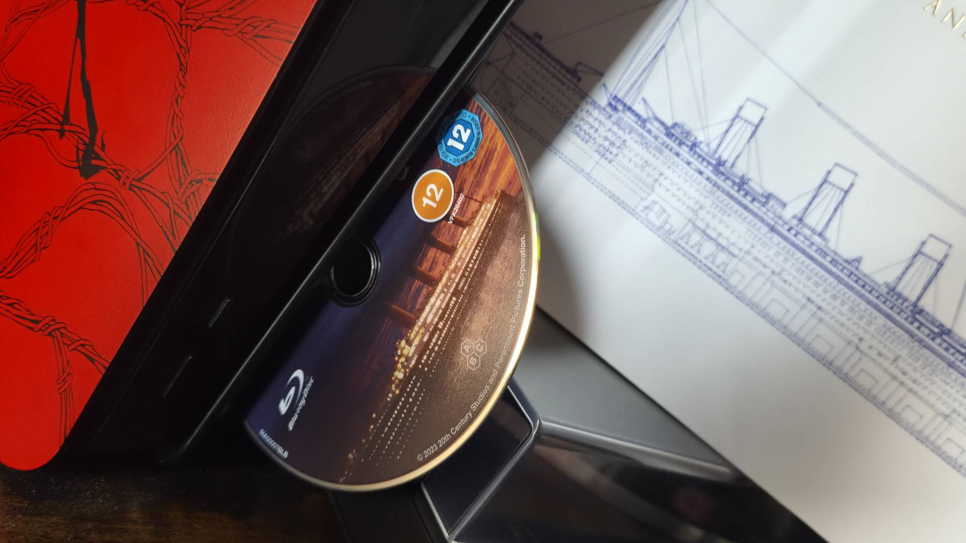 Close up of a Blu-ray popping out the launch-model PS5 disc drive.