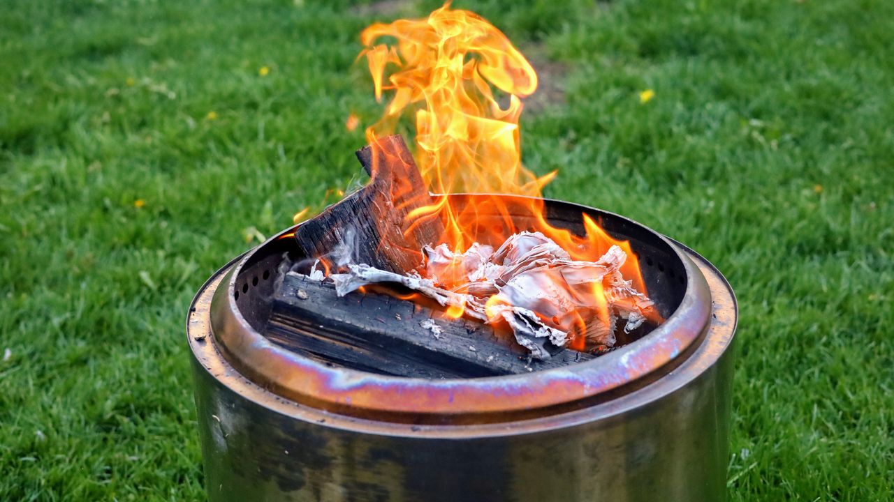 A smokeless fire pit in a backyard