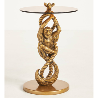 Glass side table with gold monkey shaped base
