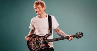 Ed Sheeran with his new PRS SE Ed Sheeran Cosmic Splash Hollowbody Baritone Piezo, a limited edition signature guitar featuring his own original artwork.
