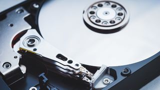 A close up image of an open hard disk drive, representing an article about how to recover data from a hard drive