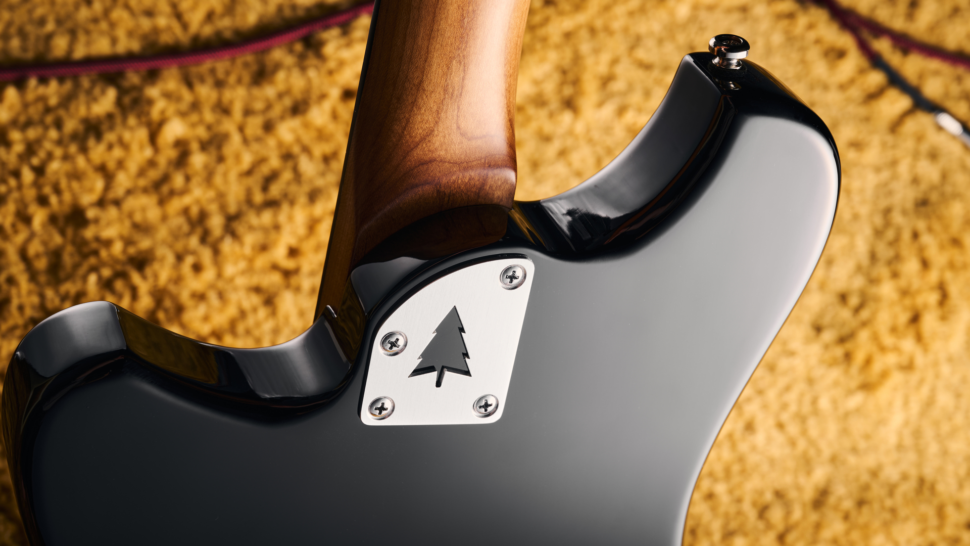 The neck plate of the Orangewood Del Sol Baritone guitar