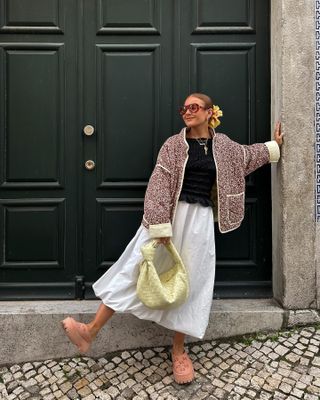 The influencer carries a butter yellow bag.