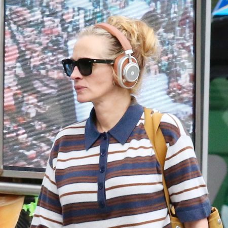 Julia Roberts in NYC wearing a striped polo shirt with straight-leg jeans and minimalist ballet flats