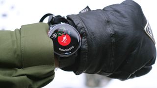 Polar Vantage V3 on the wrist of a snowboarder with mittens on