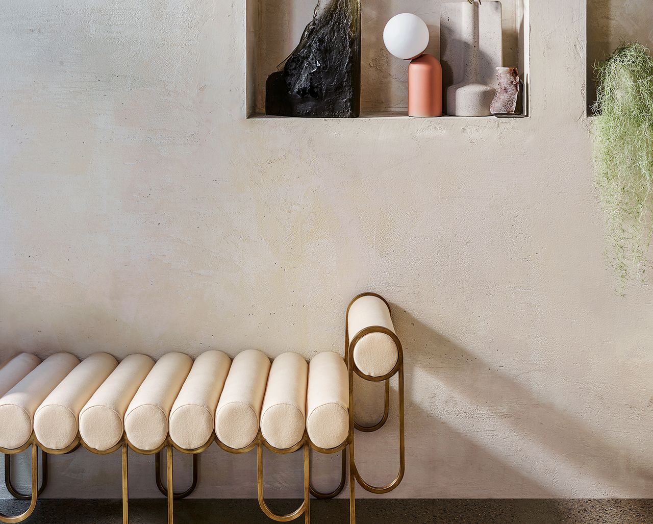 white boucle bench against a limewash gray wall