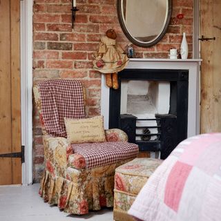 brick wall fire place with arm chair