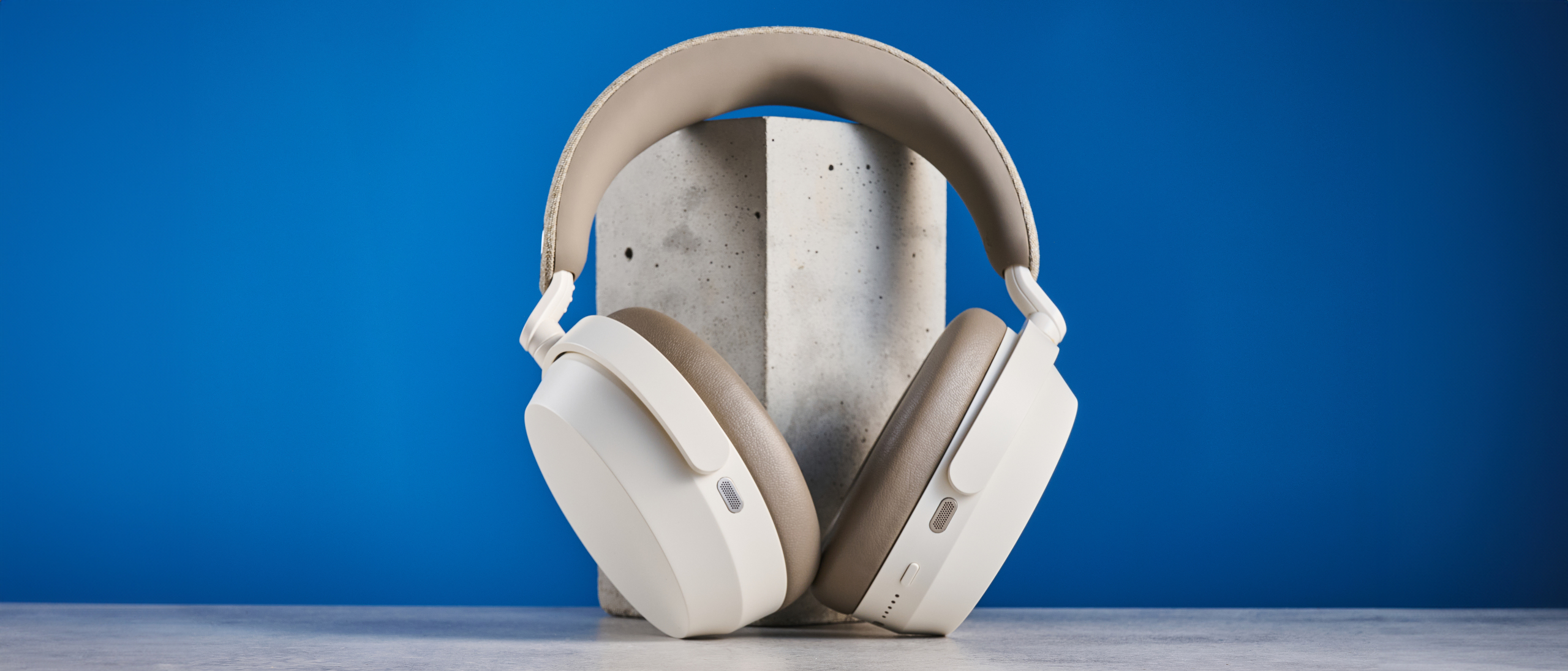 the sennheiser momentum 5 in white photographed against the blue tom's guide background