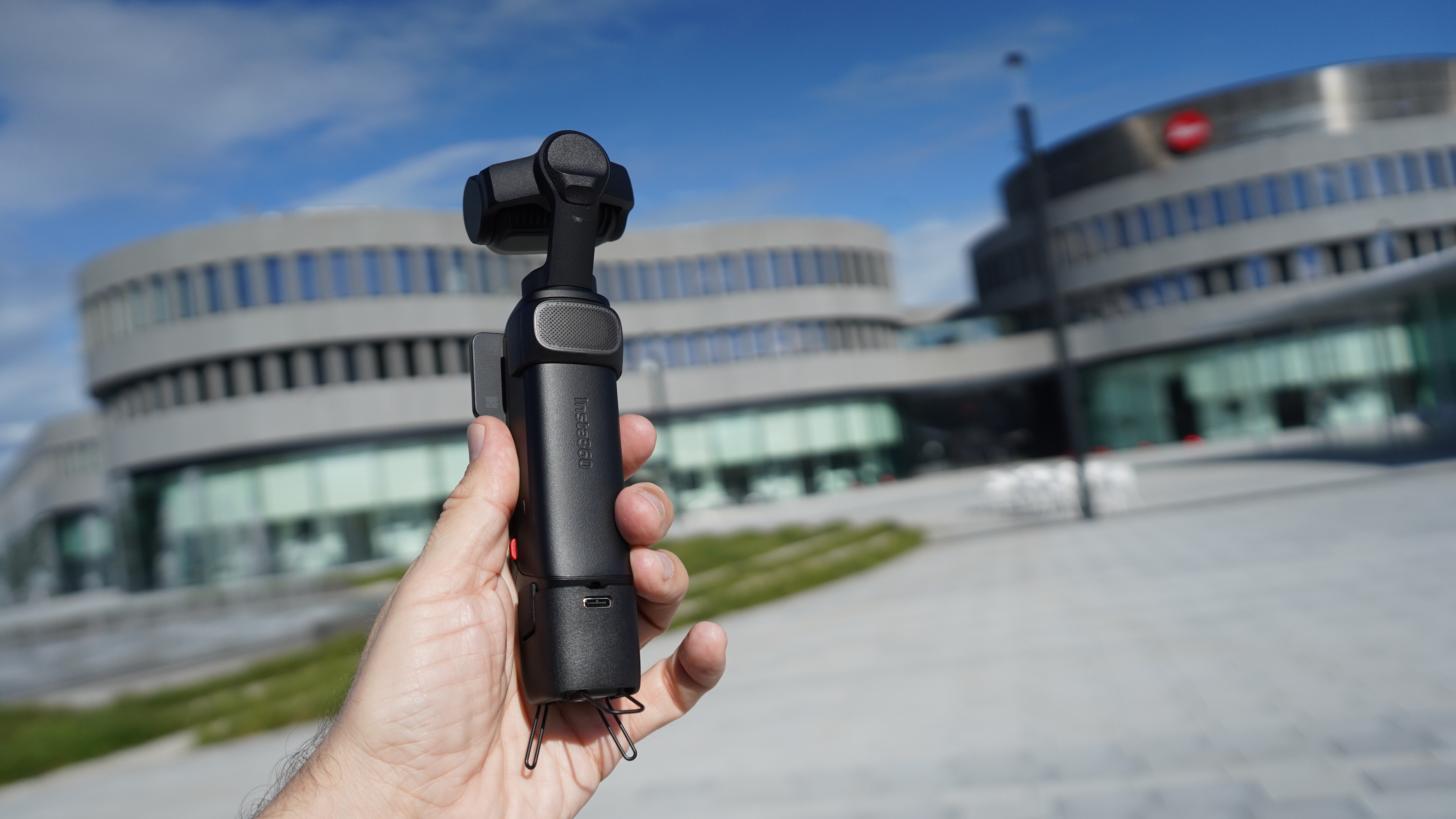 Insta360 Luna Ultra in hand in front of Leica campus