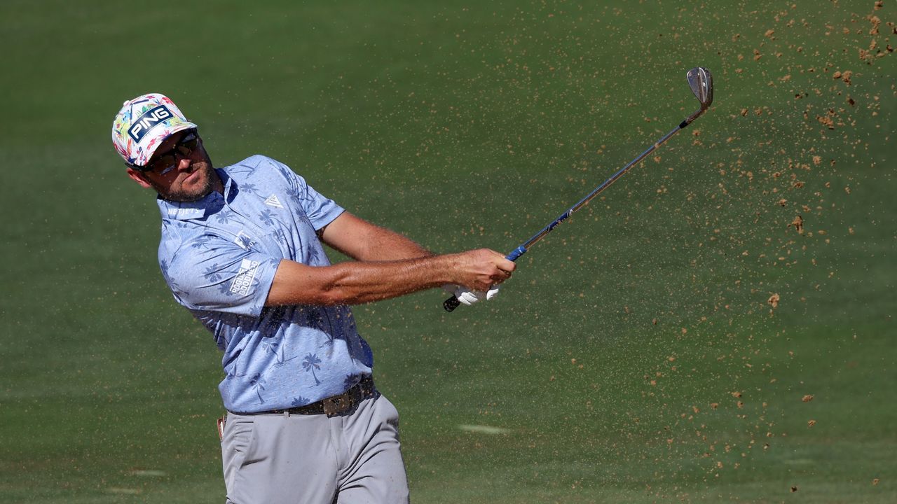 Corey Conners plays a shot from a bunker on the 16th at the Sentry TOC