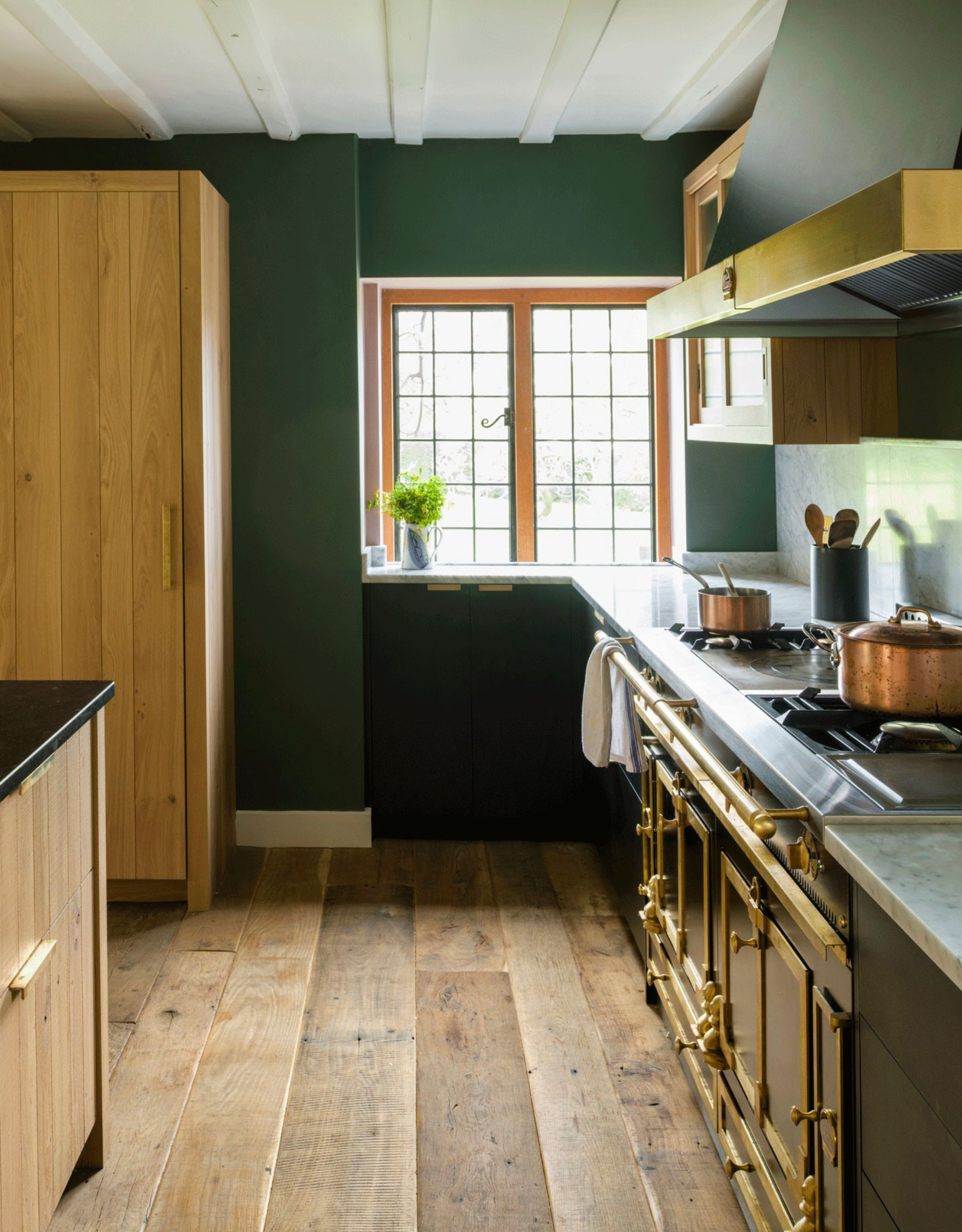 country-style kitchen with a traditional range hob, wooden flooring, and wooden cabinetry