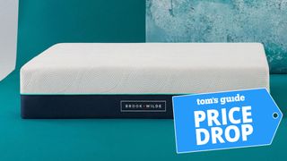 The Brook + Wilde Elite mattress on a teal background with a price drop mattress sales badge overlaid on the image