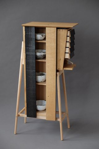 Small shelving cabinet holding bowls